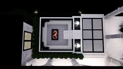 Aerial of the sunken fire pit with fire burning, lit steps down to the seating