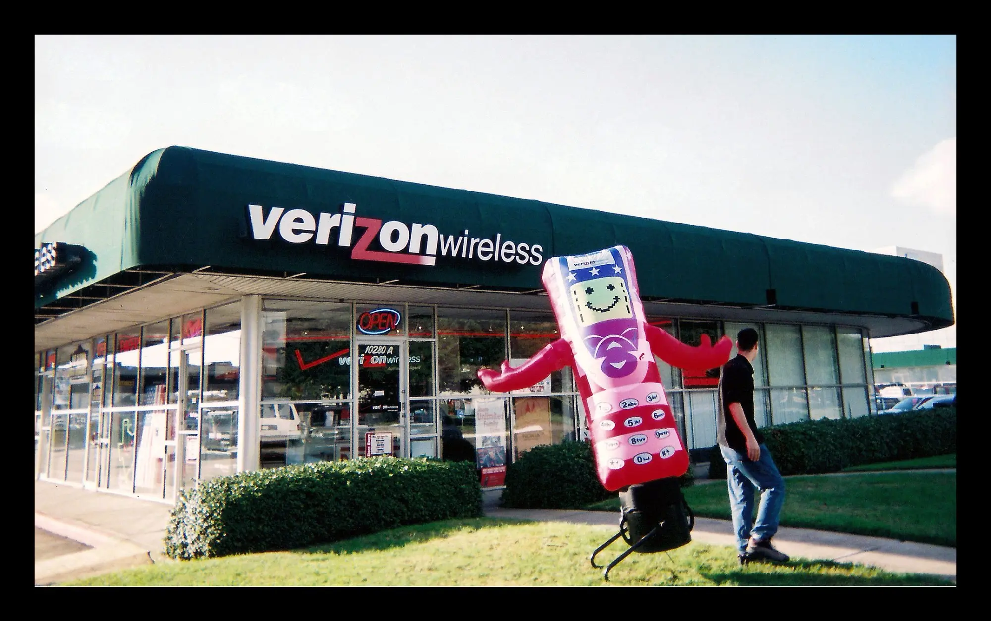 Beltway 8 store at Westheimer and Sam Houston Tollway, Houston — Mr. Happy the inflatable phone mascot out front